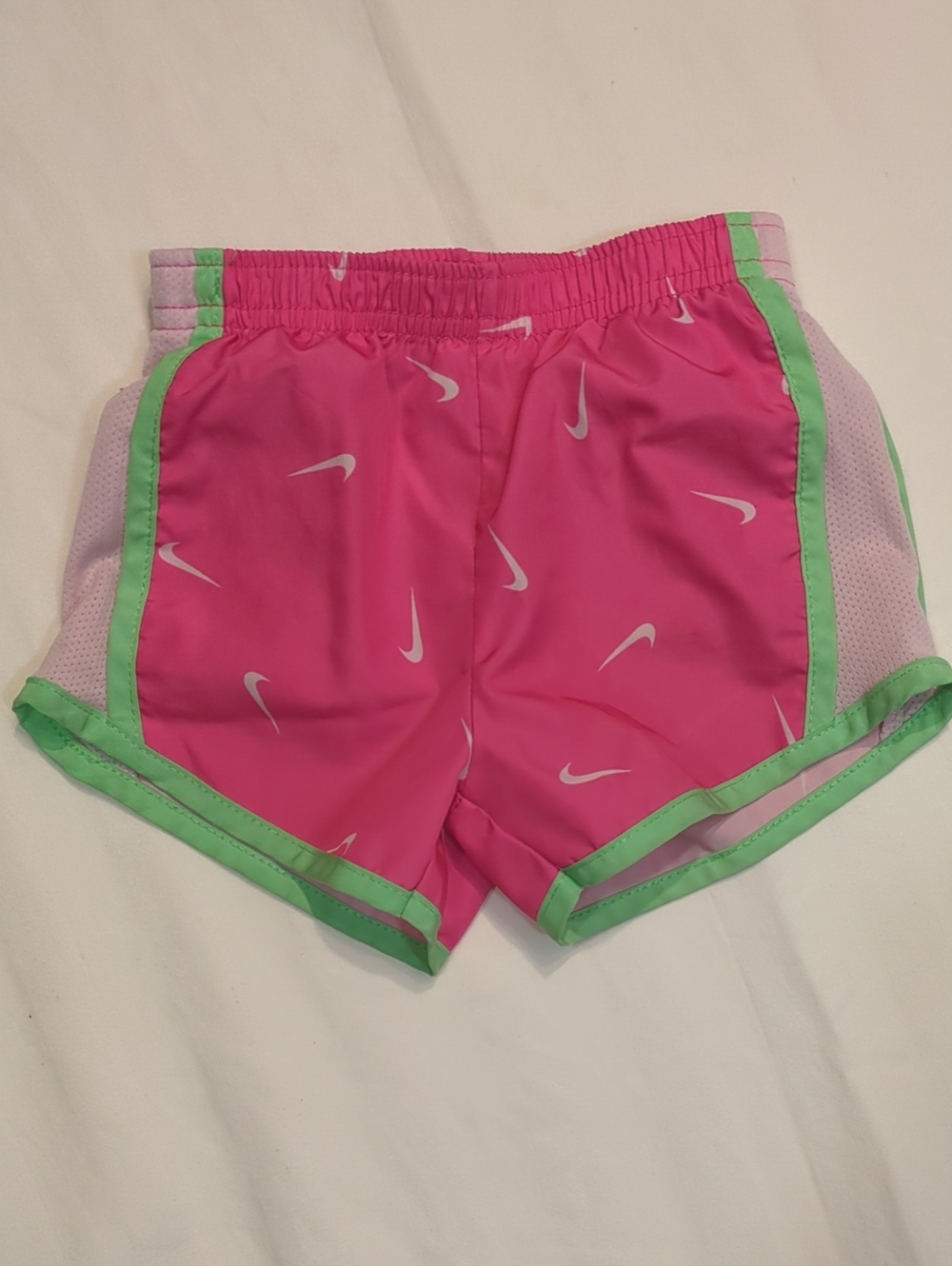 Nike Pink Shorts with Green Trim and White Swooshes
